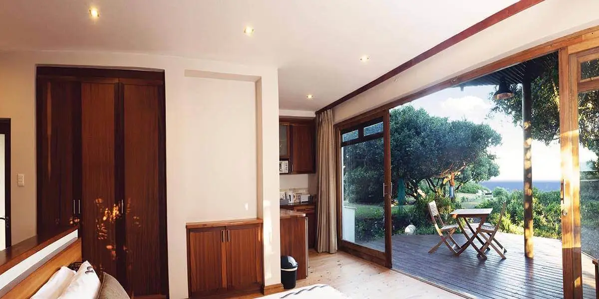 Dolphin suite opening onto a private deck and coastal garden
