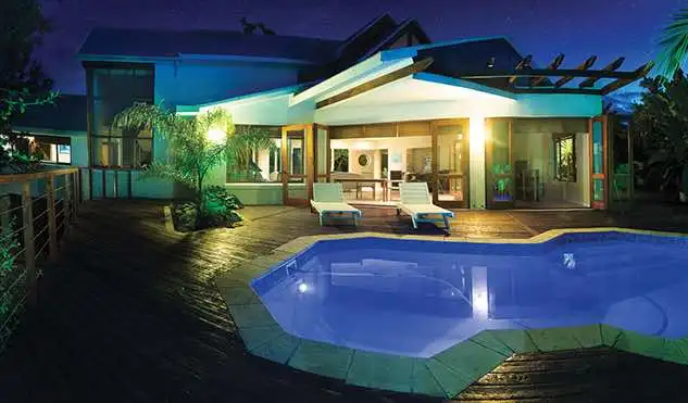 The illuminated swimming pool at Aquarius Beach House