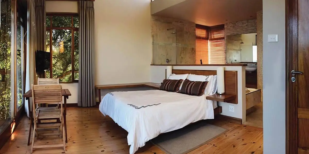 Pearl suite with a queen bed, timber floors and doors opening to the garden